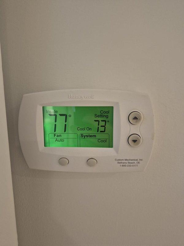 Completed HVAC system evaluation and provided estimate for boiler replacement. Inspection revealed heavily corroded evaporator coil with significant oxidation and discoloration throughout copper tubing, along with mineral deposits in drain pan indicating long-term moisture exposure and diminished system efficiency. Documented existing Honeywell thermostat currently operating in cooling mode with 4-degree temperature differential, confirming active system operation during assessment.