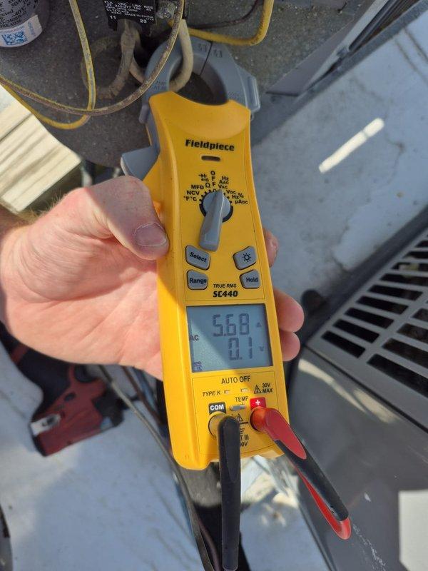Performed routine HVAC maintenance and cooling system inspection. Measured supply air temperature at 53.4°F and recorded electrical readings of 568V and 71A using clamp meter to verify proper system operation. All parameters within normal operating range, unit functioning as designed.