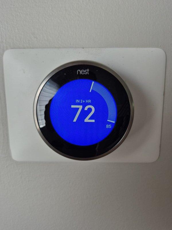 # HVAC Service Report

## No Cooling Issue - Residential Air Conditioning System

Responded to service call for air conditioning system not reaching set temperature. Upon arrival, found Nest thermostat displaying target temperature of 72°F with current ambient temperature at 85°F, indicating a 13-degree temperature differential and system unable to satisfy cooling demand.

Performed diagnostic evaluation of 2003 vintage HVAC system (20+ years old). Inspected exterior condensing unit and associated refrigerant line connections. Noted significant corrosion and oxidation on copper refrigerant lines and shutoff valve assemblies at outdoor unit, with visible blue-green patina indicating prolonged exposure to environmental conditions. Corrosion patterns suggest potential refrigerant line integrity concerns and possible restriction or leak points affecting system performance.

Given the advanced age of the equipment (exceeding typical 15-year service life expectancy) and visible deterioration