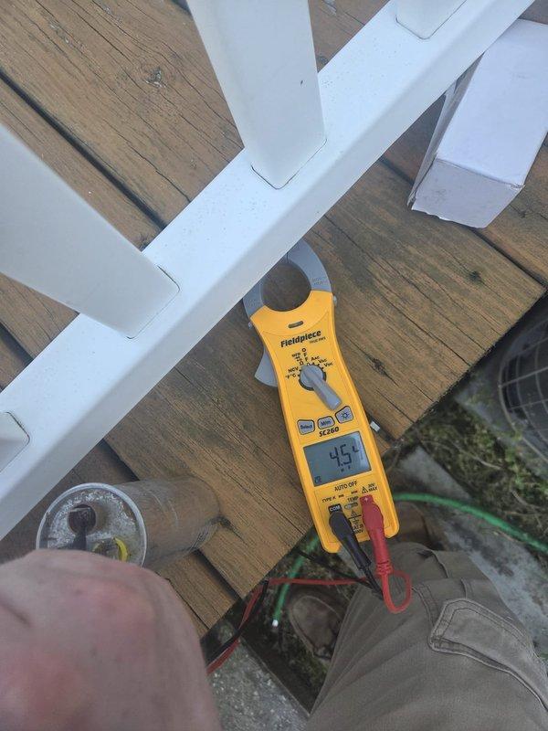 Responded to no cooling call with customer reporting 80-degree indoor temperature and WiFi thermostat alert. Upon arrival, performed electrical diagnostics on outdoor condensing unit using digital multimeter and clamp meter. Measured capacitor readings showing 751 microfarads, indicating failed run capacitor preventing compressor operation. Replaced defective dual run capacitor, verified proper amperage draws on compressor and condenser fan motor, and restored system to normal cooling operation with all components running within manufacturer specifications.