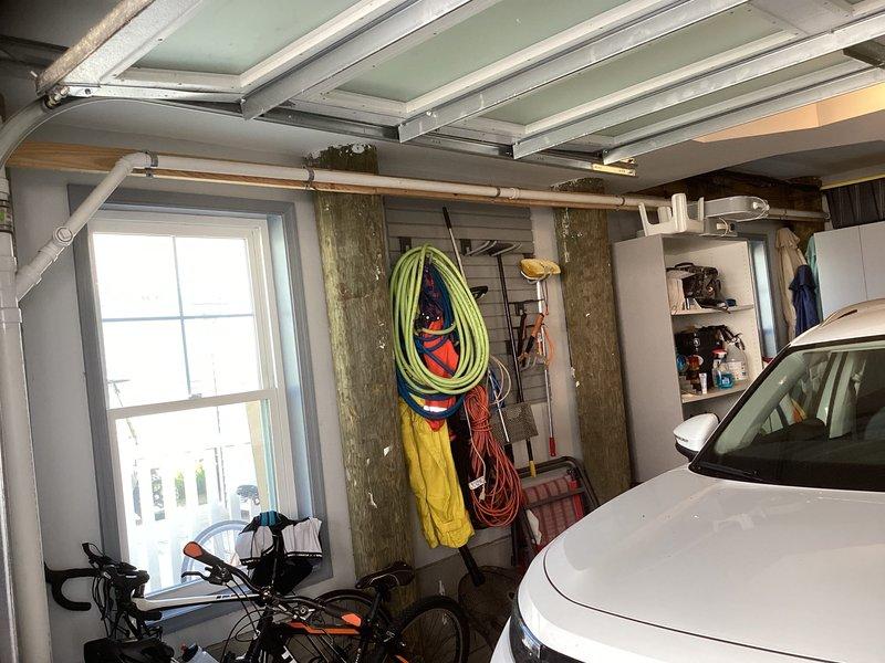Conducted site assessment for mini split installation in detached garage storage area. Evaluated electrical requirements, mounting locations, and condensate drainage options for climate control system in approximately 150-200 square foot space currently used for recreational equipment storage. Documented existing conditions including structural support posts, overhead garage door mechanisms, and available wall space to determine optimal placement for indoor air handler unit and outdoor condenser location.