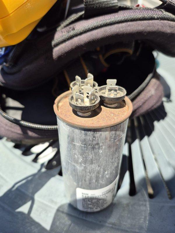 Responded to customer concern regarding insufficient cooling performance. Upon inspection, found aged capacitor showing significant corrosion and oxidation on terminals and housing, along with damaged ductwork insulation with multiple tears exposing foil backing. Measured supply air temperature at 57°F. Evaluated system components and determined capacitor replacement necessary to restore proper cooling capacity and system efficiency.