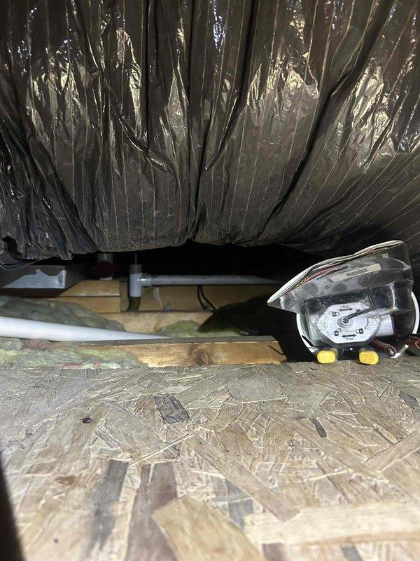 Responded to service call for water leakage from ceiling in unit Q-219. Upon investigation, located source of leak in attic/crawl space area where condensate drain line had developed a failure point. Inspected HVAC system components and drainage infrastructure, identifying compromised PVC drain pipe connection causing water to overflow and seep through ceiling below. Performed necessary repairs to condensate drainage system, securing proper pipe connections and ensuring adequate slope for drainage. Tested system operation and verified leak was resolved with no further water discharge. Cleaned affected area and confirmed all mechanical components functioning properly.
