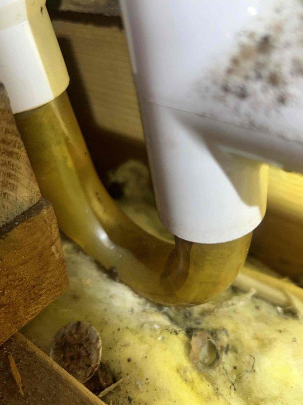 Responded to service call for water leakage from ceiling in unit Q-219. Upon investigation, located source of leak in attic/crawl space area where condensate drain line had developed a failure point. Inspected HVAC system components and drainage infrastructure, identifying compromised PVC drain pipe connection causing water to overflow and seep through ceiling below. Performed necessary repairs to condensate drainage system, securing proper pipe connections and ensuring adequate slope for drainage. Tested system operation and verified leak was resolved with no further water discharge. Cleaned affected area and confirmed all mechanical components functioning properly.