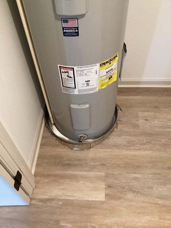 Installed a 50-gallon Bradford White tall water heater (model RE250T6) in residential property being prepared for rental. Positioned unit on 22-inch aluminum drain pan on laminate flooring in utility closet. Connected water supply lines using two 24-inch stainless steel flex connectors with appropriate brass fittings including 3/4" brass tee, 90-degree elbow, and nipples of varying lengths.

Relocated existing main water shut-off valve from top of previous heater location to new position beside tank at lower height for improved accessibility. Replaced old 3/4" CPVC ball valve with new 3/4" brass FIP ball valve. Fabricated and installed approximately 10 feet of 3/4" CPVC piping to accommodate new valve location using brass and CPVC fittings as needed.

Installed thermal expansion tank to protect plumbing system from pressure fluctuations. Integrated 3/4" male high-temperature dielectric union for proper connections. Secured all piping to wall using black plastic pipe clamps at multiple 
