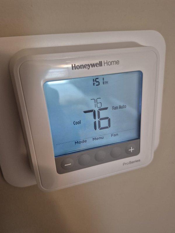 Completed preventive maintenance on two cooling systems. Verified thermostat operation showing 76°F setpoint with system in cooling mode and fan set to auto. Measured supply air temperature at 73.3°F at ductwork, confirming proper cooling output and system performance within normal operating parameters.