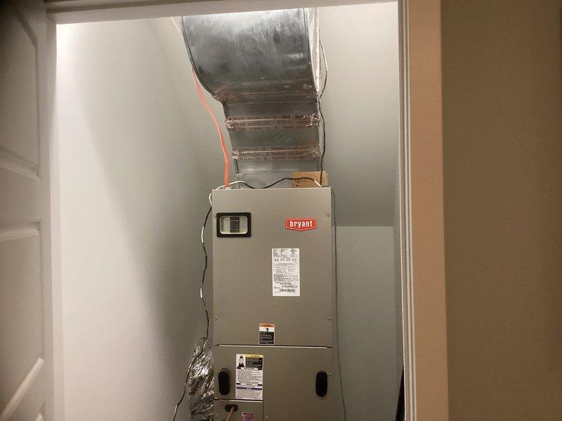 Conducted site evaluation of two residential HVAC systems, ages 14 and 16 years, both exhibiting significant corrosion but currently operational. Assessed Bryant air handler unit (model THRD42S41S1AS, serial W0G9985378, manufactured 2009) and associated ductwork for replacement consideration. Documented equipment condition with photographs showing existing installations, flexible ductwork connections, and mechanical room configurations to provide comprehensive replacement quote for dual system upgrade.