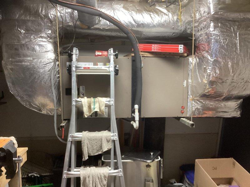 Conducted site evaluation of two residential HVAC systems, ages 14 and 16 years, both exhibiting significant corrosion but currently operational. Assessed Bryant air handler unit (model THRD42S41S1AS, serial W0G9985378, manufactured 2009) and associated ductwork for replacement consideration. Documented equipment condition with photographs showing existing installations, flexible ductwork connections, and mechanical room configurations to provide comprehensive replacement quote for dual system upgrade.