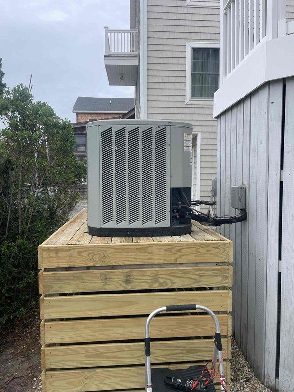 Responded to no cooling call on top floor unit. Upon inspection, discovered severe corrosion on refrigerant line connections at the outdoor condensing unit, causing refrigerant leak and loss of system charge. The corroded pipe joints showed extensive rust degradation and flaking at connection points, compromising system integrity. Documented equipment condition with photos showing the elevated condensing unit installation and deteriorated piping requiring immediate attention to restore cooling function.