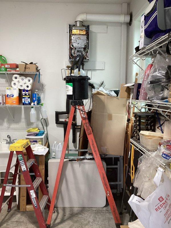 Performed comprehensive inspection and flush service on wall-mounted tankless water heater unit. Accessed internal components, verified proper operation of heating elements and control systems, and completed descaling flush procedure to remove mineral buildup and maintain optimal efficiency. All plumbing connections, copper piping, expansion tank, and PVC exhaust venting were inspected and confirmed to be functioning properly with no leaks detected.