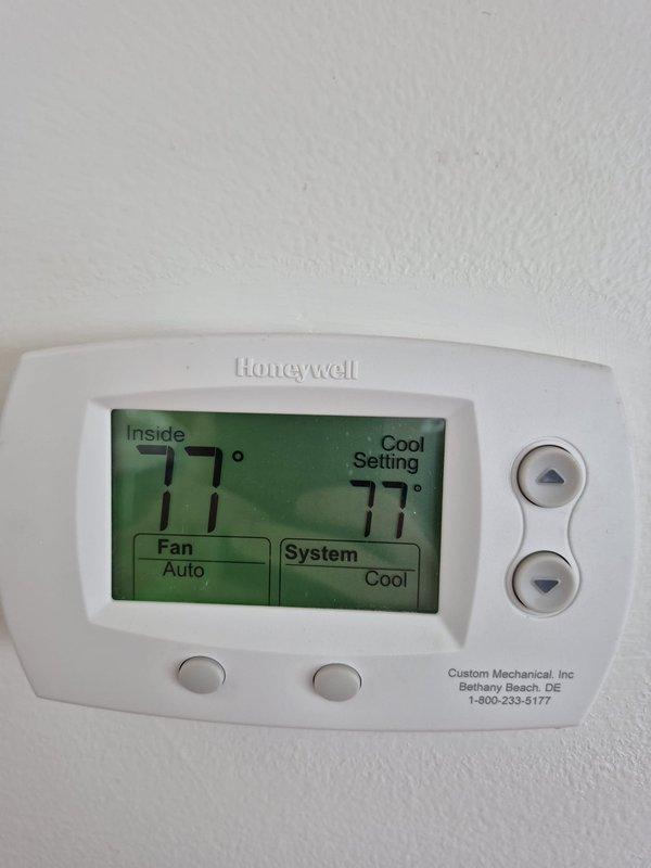 Performed cooling system maintenance check on Daikin wall-mounted mini-split unit. Verified system operation with thermostat set to 77°F in cooling mode with auto fan setting, measured supply air temperature at 62°F from evaporator discharge, confirming proper cooling performance and adequate temperature differential.