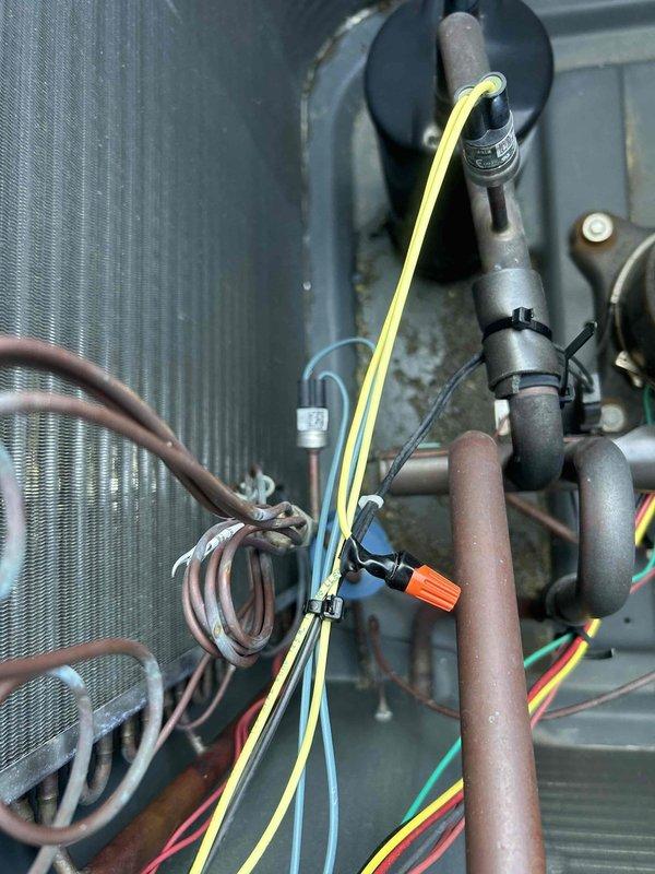 Responded to no cooling or heating call and performed diagnostic inspection of HVAC system. Upon arrival, confirmed system was not operating in either heating or cooling mode. Conducted thorough examination of internal components including evaporator coil, refrigerant lines, electrical connections, and capacitor. Inspected wiring harnesses, wire nuts, and all electrical terminations for proper connections and signs of failure. Documented system condition with photos showing coil assembly, copper refrigerant piping, capacitor, and complete wiring configuration for further evaluation and repair recommendations.