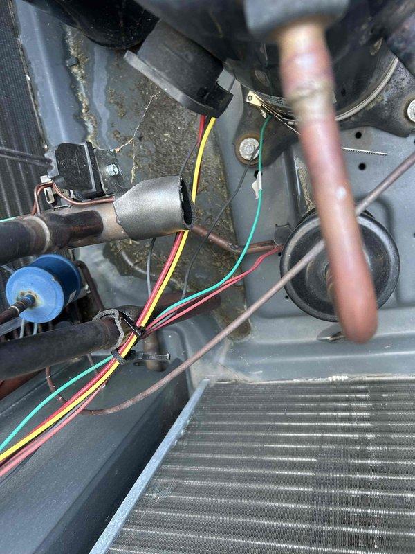 Responded to no cooling or heating call and performed diagnostic inspection of HVAC system. Upon arrival, confirmed system was not operating in either heating or cooling mode. Conducted thorough examination of internal components including evaporator coil, refrigerant lines, electrical connections, and capacitor. Inspected wiring harnesses, wire nuts, and all electrical terminations for proper connections and signs of failure. Documented system condition with photos showing coil assembly, copper refrigerant piping, capacitor, and complete wiring configuration for further evaluation and repair recommendations.