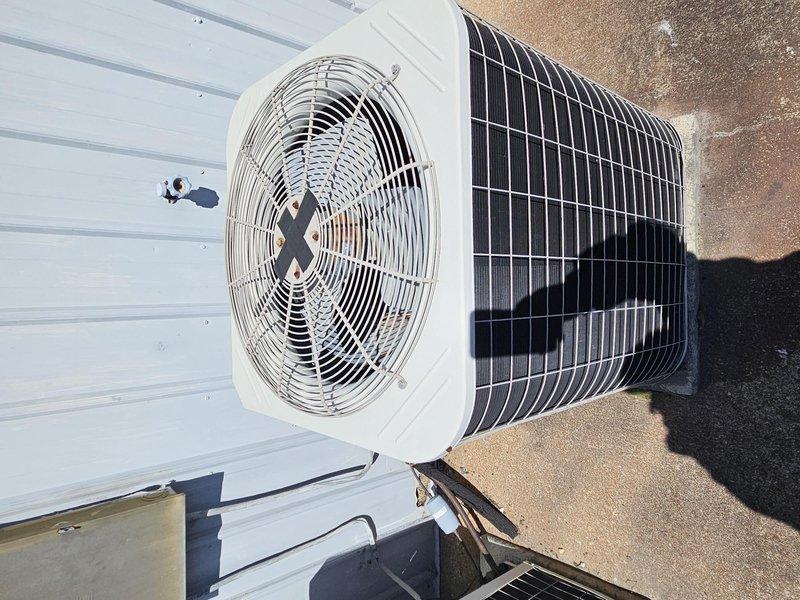 Completed estimate for complete HVAC system replacement including indoor air handler unit and outdoor condensing unit. Documented existing equipment configuration with indoor unit mounted on interior wall with refrigerant lines, condensate drain with proper trap, and connected ductwork plenum, along with outdoor rooftop-mounted condensing unit featuring cylindrical fan housing and condenser coil assembly.