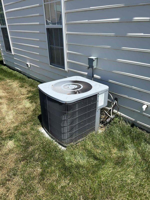 Performed routine cooling system maintenance on residential air conditioning unit. Accessed property via lockbox at front door and secured premises upon completion. Conducted comprehensive inspection of outdoor condenser unit, verifying proper operation of compressor and condenser fan motor. Examined condenser coils for debris accumulation and airflow restrictions. Checked electrical connections at outdoor disconnect and verified proper voltage supply. Inspected electrical panel for HVAC circuit breaker functionality and confirmed water heater circuit labeling. Documented system condition through photographic records showing condenser unit placement, exterior electrical components, and main electrical panel with current inspection permits. Unit operating within normal parameters with no immediate service requirements identified.