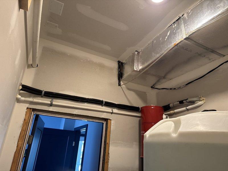 Completed installation of Mitsubishi ductless mini-split system consisting of MUZ-FX09NL outdoor condensing unit and MSZ-FX09NL indoor fan coil unit. Mounted outdoor unit on stainless steel wall bracket on east exterior wall adjacent to existing HVAC equipment. Installed indoor fan coil on closet wall in ground floor gym area. Ran refrigerant lines, condensate drain, and low voltage control wiring between indoor and outdoor units with proper insulation and support. Installed surge disconnect at outdoor unit location. System tested and confirmed operational with proper refrigerant charge and airflow. Customer responsible for final power wiring connection. One-year parts and labor warranty provided on ductless equipment.