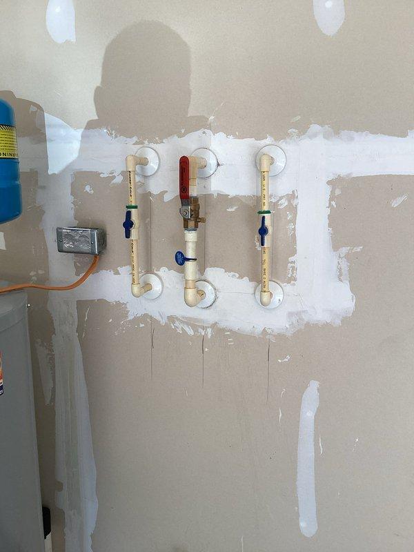 Replaced defective main water shut-off valve located in garage. Turned off water supply at street-level curb stop to isolate system. Removed old valve and installed new ball valve assembly with proper copper pipe connections. Verified all connections were secure, restored water service at street, and tested new shut-off valve for proper operation with no leaks detected.
