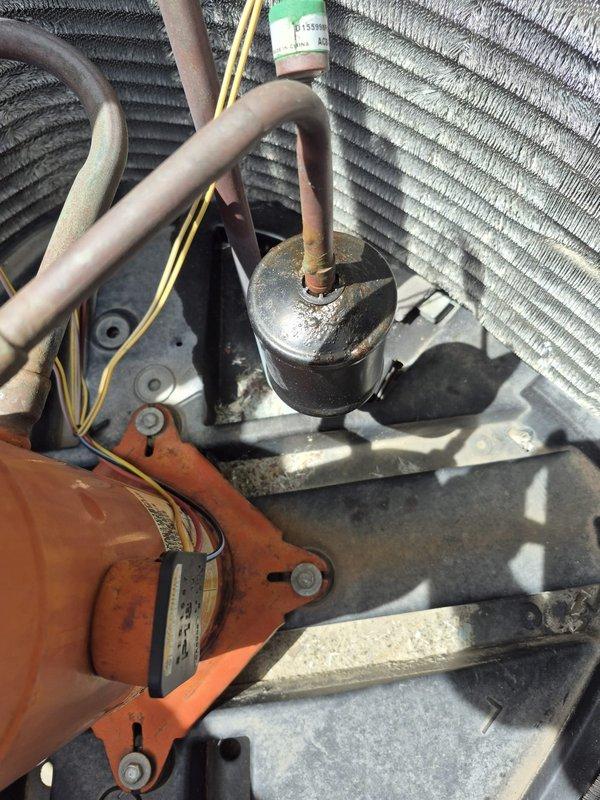 Responded to no cooling complaint at residential property. Upon inspection, found outdoor condenser unit with heavily soiled condenser coils and significant dust accumulation throughout cabinet. Internal components showed signs of age and neglect with dirt buildup on compressor, fan motor, and refrigerant lines. Performed thorough cleaning of condenser coils and interior components to restore proper airflow and heat transfer efficiency. Unit operational upon completion of service.