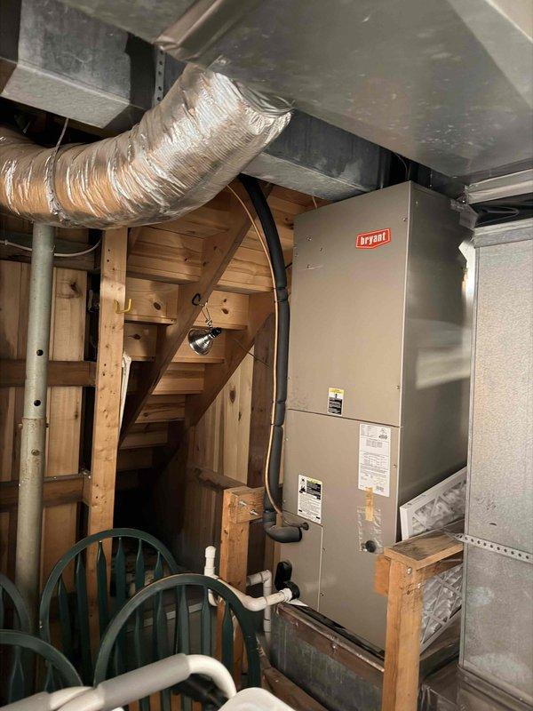 Conducted on-site evaluation of 30-year-old HVAC system located in basement for replacement estimate. Documented existing Bryant furnace and air handler equipment with photos, assessed current installation configuration including ductwork connections and PVC condensate drainage system. Customer is obtaining multiple estimates for complete system replacement.