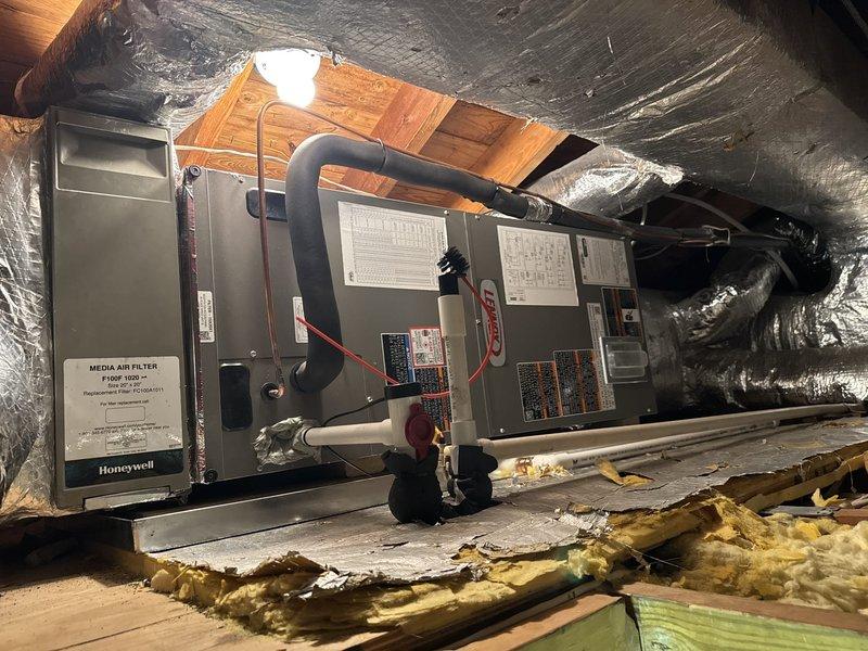 Completed full HVAC system replacement including removal and disposal of existing equipment. Installed new Lennox ML14KP1-024 2-ton 14 SEER heat pump with matching Lennox CBK45UHET-024 air handler in attic space and 10 kW electric heat pack. Fabricated and installed metal duct transitions to adapt new equipment to existing ductwork. Positioned outdoor condenser unit on existing pad with new electrical disconnect and whip. Reused existing refrigerant lines and condensate drain. Mounted Honeywell digital WiFi thermostat for system control. Installed Honeywell media air filter and provided two 20x20x4 replacement filters. All electrical connections completed to code. System tested and verified operational. One-year parts and labor warranty provided on both systems from installation date.