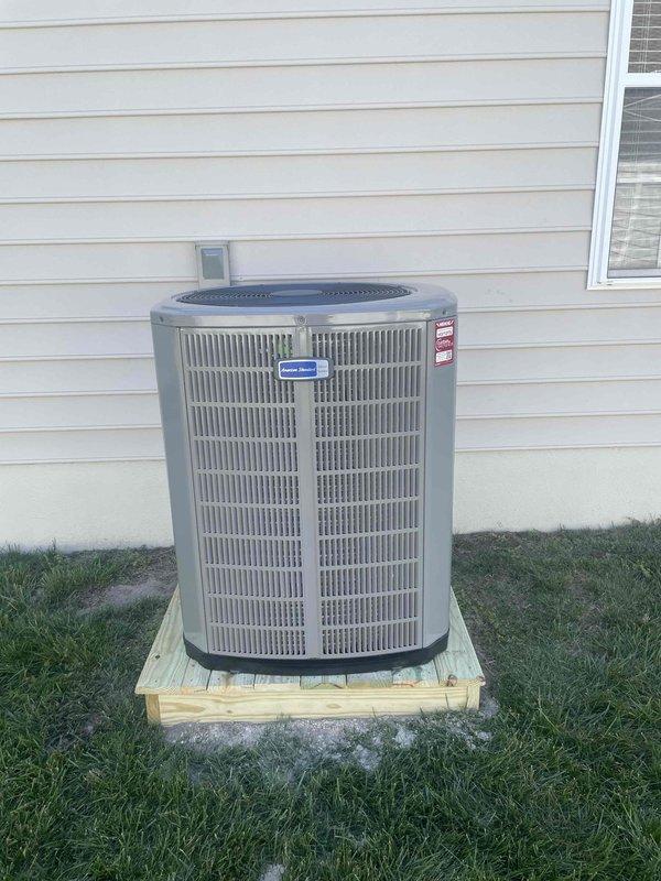 Completed full HVAC system replacement including removal and disposal of existing equipment. Installed American Standard 3.5-ton 16 SEER heat pump outdoor unit (model 5A6H5042) on wooden platform with whip, disconnect, and surge protection. Installed variable speed fan coil unit (model 5TEM6D05) in drain pan with shutoff valve and 15KW electric heat strip with breaker (model BAYHTR1715BRKR). Flushed, pressure tested, and recharged refrigeration lines to manufacturer specifications. Installed two WiFi thermostats (model S1200W) to control existing zone damper system—first floor thermostat controlling second floor zone and new thermostat for first floor zone. Utilized existing zone dampers and control board, which are not covered under new equipment warranty. System tested and operational with one-year parts and labor warranty on new equipment.