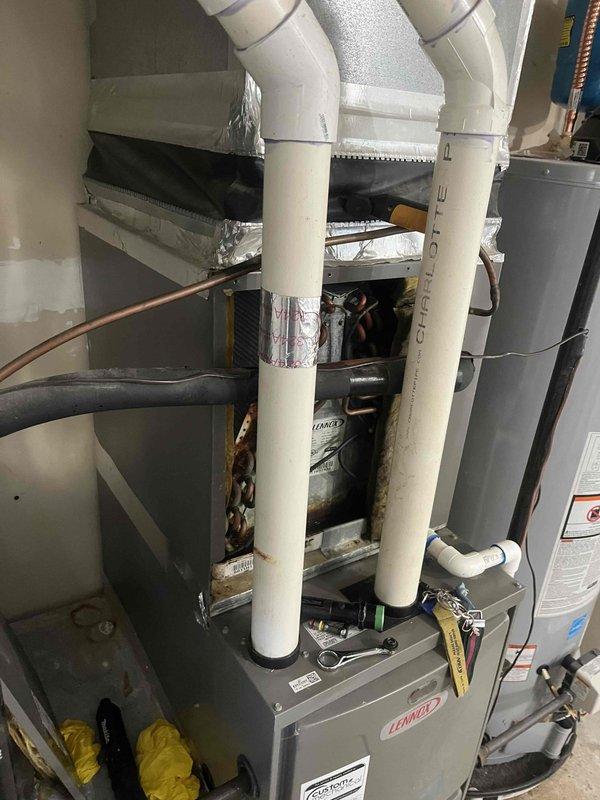 Responded to no cooling call on aging HVAC system. Upon arrival, performed diagnostic evaluation of furnace and air conditioning components in utility room. Inspected refrigerant lines, ductwork connections, and PVC venting system for proper operation. Completed necessary repairs to restore cooling function to the unit.