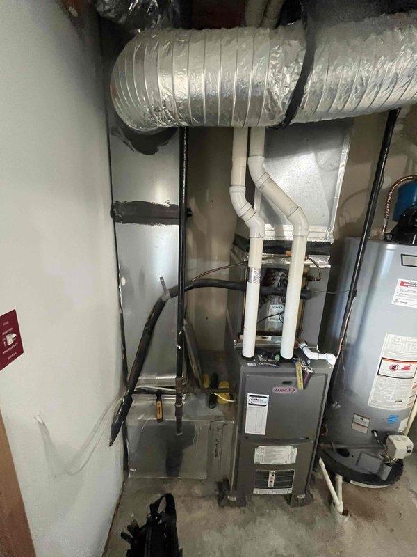 Responded to no cooling call on aging HVAC system. Upon arrival, performed diagnostic evaluation of furnace and air conditioning components in utility room. Inspected refrigerant lines, ductwork connections, and PVC venting system for proper operation. Completed necessary repairs to restore cooling function to the unit.