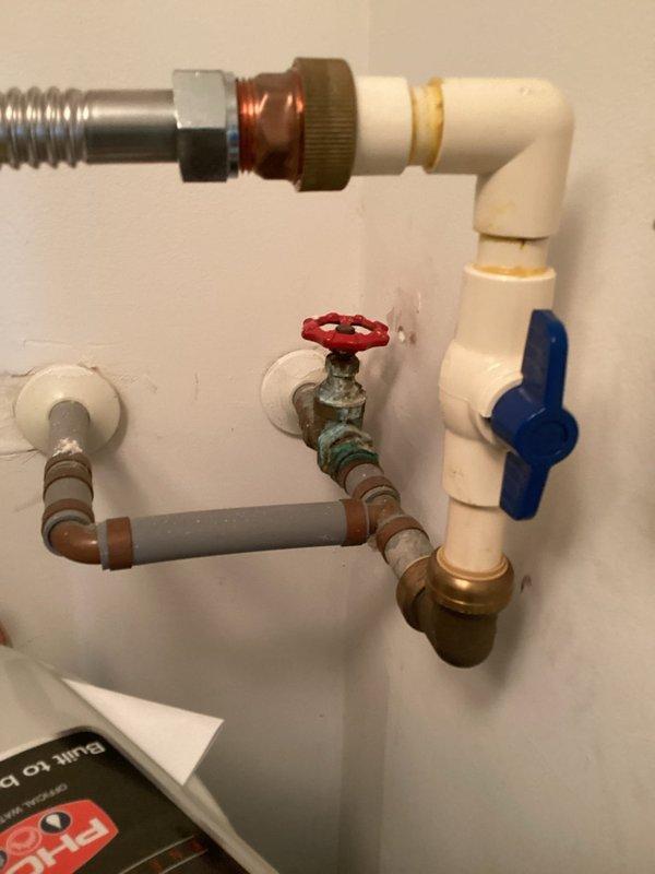 Performed routine maintenance inspection on residential tanked water heater system. Verified proper operation of all shutoff valves including red-handled and blue-handled ball valves, inspected flexible metallic connectors and PVC piping for signs of wear or deterioration, and examined compression fittings for corrosion or leaks. Confirmed water heater tank condition, checked electrical disconnect box, and documented existing patina on copper fittings. All components found to be in functional operating condition with no active leaks or immediate safety concerns identified.