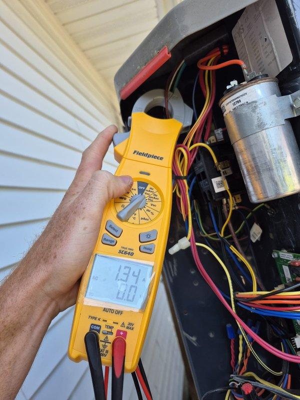Performed routine cooling maintenance visit on residential HVAC system. Conducted electrical diagnostics using digital multimeter, recording voltage and amperage readings at the outdoor condenser unit to verify proper compressor and fan motor operation. Measured supply air temperature at ductwork register, confirming 46.1°F output and adequate cooling performance. Inspected all electrical connections, capacitor condition, and wiring integrity within the condensing unit. System operating within normal parameters with no deficiencies noted.