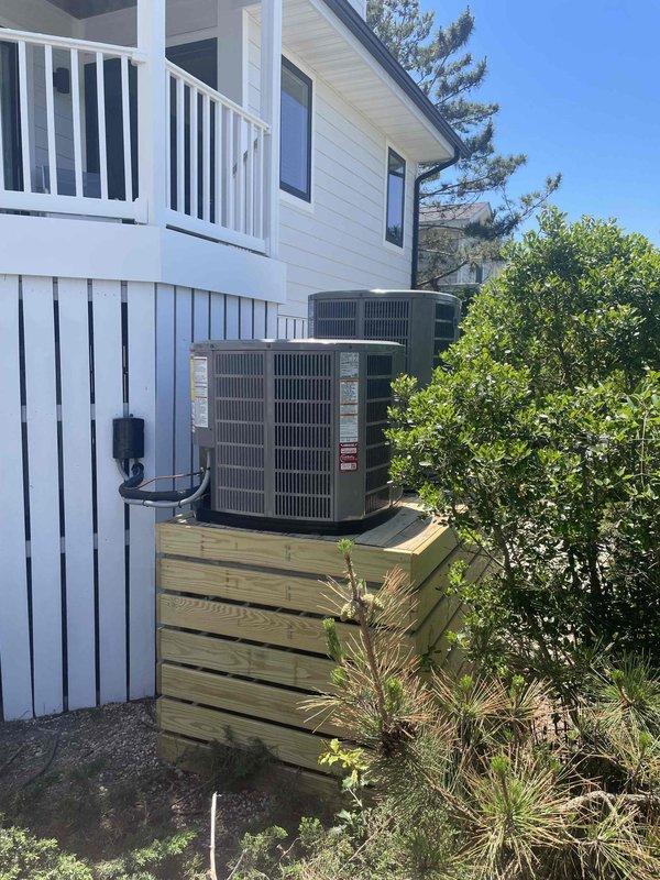 Completed full dual-zone HVAC system replacement for two-story residential property. Removed and disposed of existing systems, then installed two heat pump systems: a 3.5-ton 14 SEER unit (5A6H4042) serving the second floor and a 3.0-ton 14 SEER unit (5A6H4036) for the first floor. Both outdoor condenser units were positioned on existing wooden platform with proper clearances. Indoor air handlers (5TEM4D04 standard fan coil units) were installed with drain pans and shut-off valves, with the second-floor unit receiving additional overflow protection. Each system was equipped with 15KW electric heat strips (BAYHTR1715BRKR) for auxiliary heating. Flushed existing refrigeration linesets, performed pressure testing to verify integrity, then evacuated and recharged systems to manufacturer specifications using refrigerant manifold gauges. Installed electrical whips and disconnect boxes for both outdoor units to meet code requirements. Upgraded climate control with two Honeywell THX1200W WiFi 