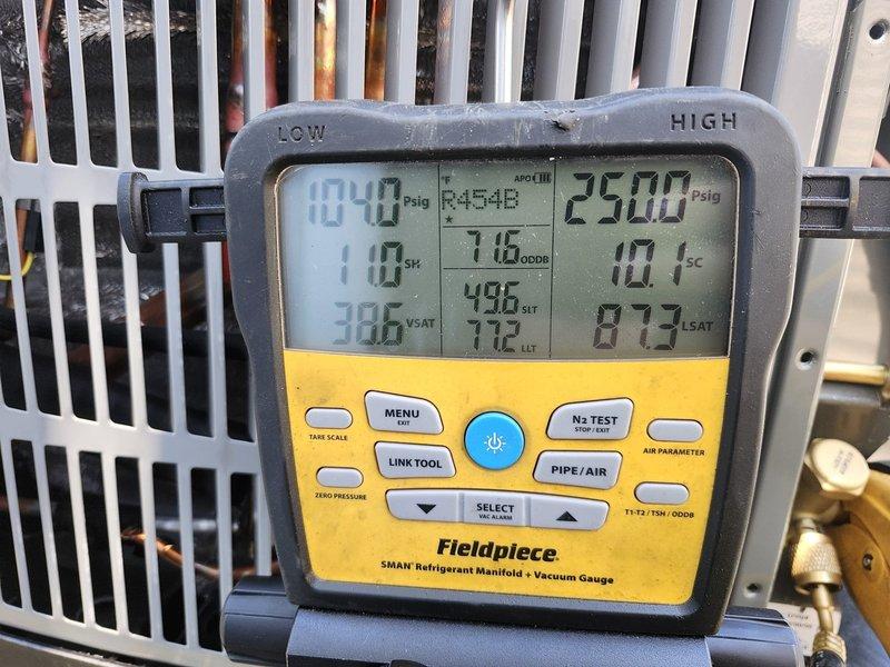 Completed full dual-zone HVAC system replacement for two-story residential property. Removed and disposed of existing systems, then installed two heat pump systems: a 3.5-ton 14 SEER unit (5A6H4042) serving the second floor and a 3.0-ton 14 SEER unit (5A6H4036) for the first floor. Both outdoor condenser units were positioned on existing wooden platform with proper clearances. Indoor air handlers (5TEM4D04 standard fan coil units) were installed with drain pans and shut-off valves, with the second-floor unit receiving additional overflow protection. Each system was equipped with 15KW electric heat strips (BAYHTR1715BRKR) for auxiliary heating. Flushed existing refrigeration linesets, performed pressure testing to verify integrity, then evacuated and recharged systems to manufacturer specifications using refrigerant manifold gauges. Installed electrical whips and disconnect boxes for both outdoor units to meet code requirements. Upgraded climate control with two Honeywell THX1200W WiFi 