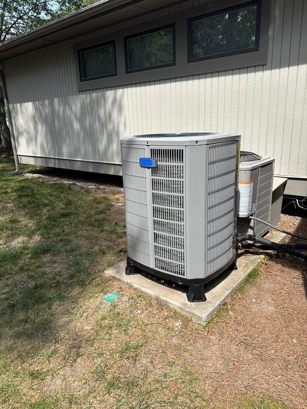 Completed full HVAC system replacement including removal and disposal of existing equipment. Installed 2-ton 17 SEER heat pump outdoor unit on existing concrete pad with risers, mounted variable speed communicating fan coil unit in drain pan with shutoff in attic space. Installed 10KW electric heat strip with dedicated breaker as auxiliary heat source. Flushed and pressure tested refrigeration lines, evacuated system and charged to manufacturer specifications. Installed surge disconnect and whip at outdoor unit for electrical protection. Mounted variable speed communicating thermostat for system control. All components tested and verified operational upon completion.