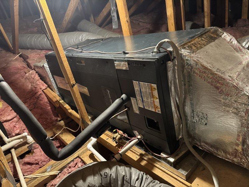 Completed full HVAC system replacement including removal and disposal of existing equipment. Installed 2-ton 17 SEER heat pump outdoor unit on existing concrete pad with risers, mounted variable speed communicating fan coil unit in drain pan with shutoff in attic space. Installed 10KW electric heat strip with dedicated breaker as auxiliary heat source. Flushed and pressure tested refrigeration lines, evacuated system and charged to manufacturer specifications. Installed surge disconnect and whip at outdoor unit for electrical protection. Mounted variable speed communicating thermostat for system control. All components tested and verified operational upon completion.