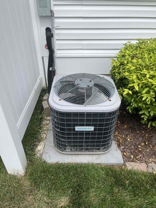 # HVAC Service Call Summary

Responded to no air conditioning complaint at residential property. Upon arrival, inspected outdoor condensing unit and electrical service panel. Unit is 10+ years old and located on exterior concrete pad with adequate clearance. Verified electrical connections at breaker panel, documented system configuration, and assessed overall equipment condition. Photographed electrical panel labeling and outdoor unit installation for service records.

# Detailed Work Performed

Arrived at property during scheduled service window to diagnose air conditioning system failure. Conducted visual inspection of outdoor condensing unit positioned on concrete pad along exterior wall. Unit showed typical age-related wear consistent with 10+ year operation. Refrigerant line set properly secured to building exterior with black insulation intact.

Inspected main electrical service panel to verify circuit breaker configuration and proper labeling. All circuits clearly marked with h