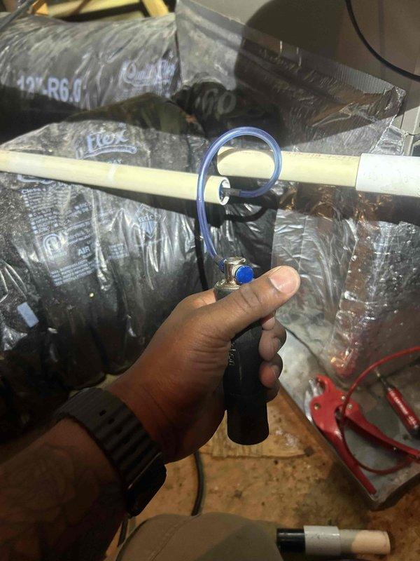 Responded to no cooling call on upstairs system that was not operational over the weekend. Diagnosed intermittent thermostat failure causing system malfunction. Identified clogged condensate drain line with rust-colored debris buildup restricting proper drainage. Cleared blockage from drain line, verified proper condensate flow, and tested system operation to confirm cooling restored.