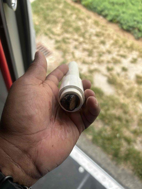 Responded to no cooling call on upstairs system that was not operational over the weekend. Diagnosed intermittent thermostat failure causing system malfunction. Identified clogged condensate drain line with rust-colored debris buildup restricting proper drainage. Cleared blockage from drain line, verified proper condensate flow, and tested system operation to confirm cooling restored.