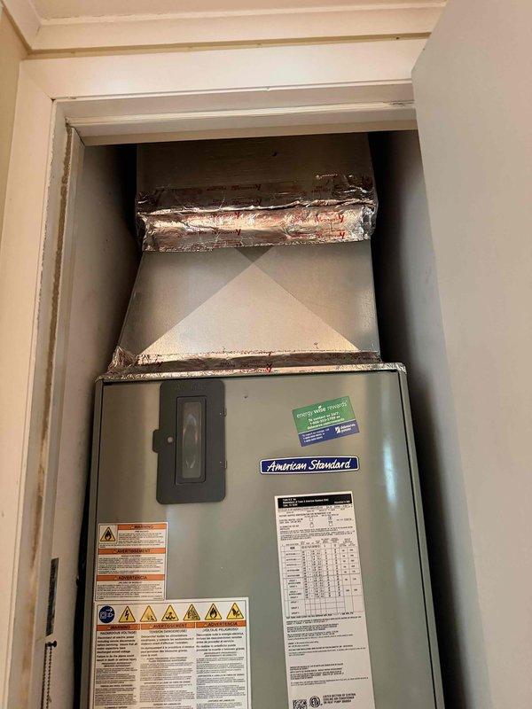 Provided estimate for replacement of existing American Standard air handler system. Unit is currently operational but aging, located in interior closet alcove with existing ductwork infrastructure. Documented existing Trane-manufactured equipment (Model 4TEE3F31B1000BA) with specifications for replacement planning.