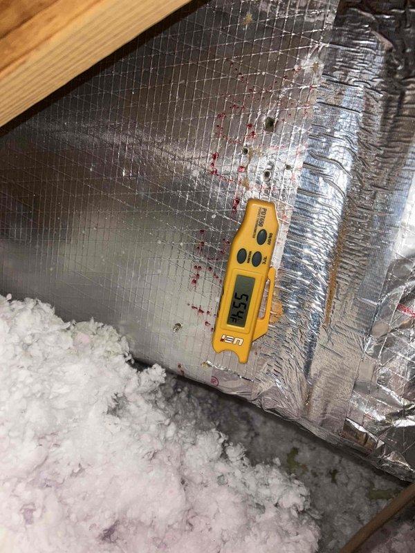 Responded to no cooling complaint on unit less than 10 years old. Upon arrival, found system running but not cooling adequately with excessive noise reported. Performed diagnostic temperature measurements at supply and return locations using digital thermometer. Supply air temperature measured 39.5°F at ductwork in attic space, while return air measured 55.9°F, indicating inadequate temperature split of approximately 16 degrees. Normal temperature differential should be 18-22 degrees for proper cooling performance. Inspected attic-mounted equipment and ductwork for visible issues. No refrigerant leaks detected during visual inspection. Unit remains noisy and not cooling to desired temperature. Further diagnostics required to identify root cause of insufficient cooling capacity and abnormal noise levels. Possible issues include low refrigerant charge, compressor inefficiency, airflow restrictions, or mechanical component failure requiring additional testing and repair.