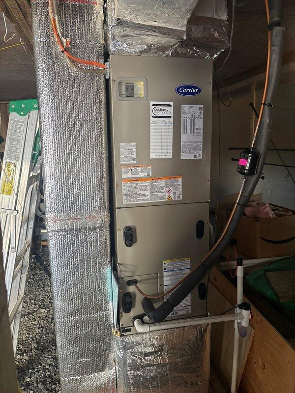 Completed full HVAC system replacement including removal and disposal of existing equipment. Installed new Carrier 27SCA536A003 3-ton 15 SEER heat pump outdoor unit on pressure-treated wood stand beneath covered porch area. Mounted Carrier FJ5ANXB36L00 air handling unit with ECM motor in interior utility space. Integrated Carrier 10kw electric heat pack for supplemental heating capacity. Fabricated and installed metal duct transitions to adapt new equipment to existing ductwork system. Reused existing refrigerant lines and condensate drainage. Replaced outdoor electrical disconnect and supply whip to meet current code requirements. Installed Honeywell digital WiFi thermostat for system control. Verified all electrical connections, refrigerant pressures, and airflow parameters. System tested and operational with one-year parts and labor warranty from installation date.