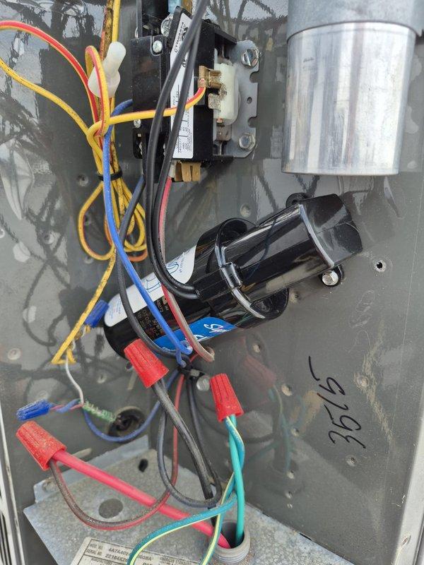 # HVAC Maintenance - Cooling System Service

Performed routine cooling maintenance visit on rooftop HVAC unit. Conducted electrical diagnostics using digital multimeter, measuring capacitor performance and electrical connections. Readings of 3.79 and 0.3 were recorded during testing. Inspected internal electrical components including cylindrical capacitor, contactors, and relay systems. Verified all wire connections, terminals, and color-coded wiring were secure and functioning properly. All components operating within normal parameters. Unit tested and left in proper working condition.