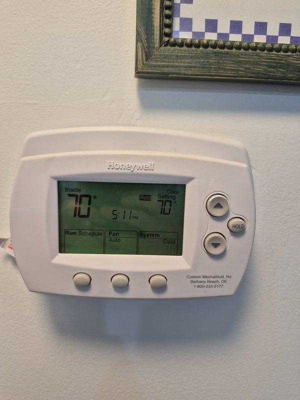 Performed cooling system maintenance including washing down the outdoor condensing unit to remove debris and restore proper airflow. Verified system operation with electrical diagnostics showing 426.5 volts and 7.1 amp draw, confirming equipment running within normal parameters. Thermostat set to cooling mode at 70 degrees with system cycling properly and maintaining desired temperature.