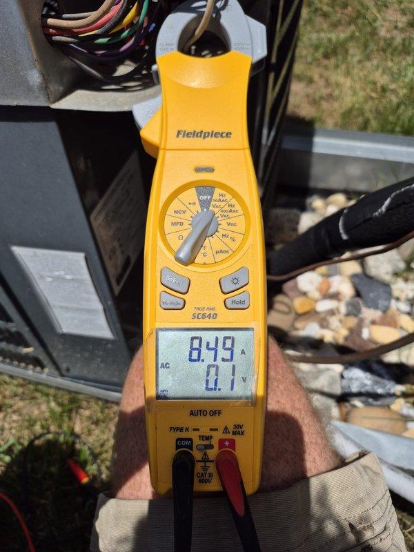 Performed comprehensive cooling system maintenance and electrical diagnostics on outdoor HVAC unit. Utilized clamp meter to measure amperage and voltage readings across multiple circuits, recording 0.49A, 5.95A, and voltage measurements to verify proper electrical operation and component performance. Inspected and tested all electrical connections, control wiring, and power supply to ensure system functionality and safety compliance.