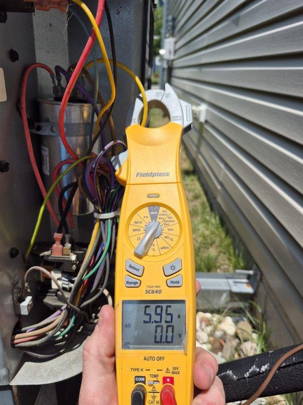 Performed comprehensive cooling system maintenance and electrical diagnostics on outdoor HVAC unit. Utilized clamp meter to measure amperage and voltage readings across multiple circuits, recording 0.49A, 5.95A, and voltage measurements to verify proper electrical operation and component performance. Inspected and tested all electrical connections, control wiring, and power supply to ensure system functionality and safety compliance.