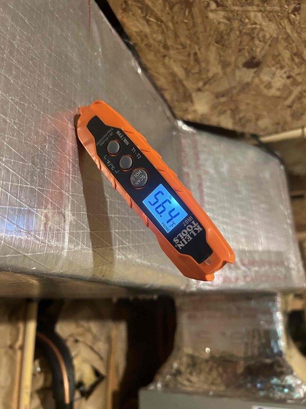 Responded to no cooling complaint for upstairs zone reading 80°F on thermostat. Performed diagnostic testing of system components using digital measurement instruments in attic space. Inspected supply ductwork, insulation, and air distribution system; removed and evaluated duct components including deflector shield and mounting hardware to assess airflow restrictions and system performance issues.