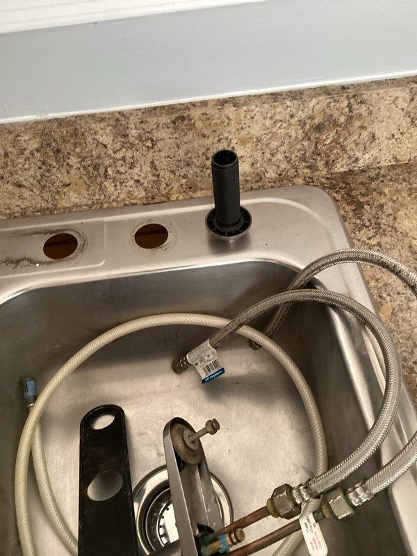 Completed comprehensive bathroom plumbing renovation including installation of kitchen sink drain assemblies with plastic tubular P-traps, end outlet waste connector, and flanged tailpiece. Installed chrome compression angle stop valves for water supply connections. Performed toilet reinstallation utilizing thin wax seals, brass adjustable closet bolts, stainless steel closet supply line, and Kohler tank-to-bowl gasket assembly. Configured water heater connections with brass fittings including tee, 90-degree elbow, and nipples of varying lengths, along with stainless steel flexible water heater connectors and aluminum drain pan for code compliance. All fixtures tested and verified operational upon completion.