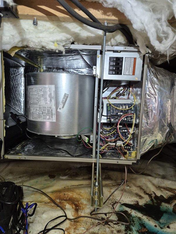 Inspected Carrier air handler model FT5ANB36L00EBAA in attic installation and identified cracked evaporator coil drain pan causing water damage to surrounding area. Ordered replacement drain pan and filter drier for warranty repair. Additionally identified improper air handler support configuration obstructing blower motor access, which will require modification to allow future serviceability and proper equipment maintenance.