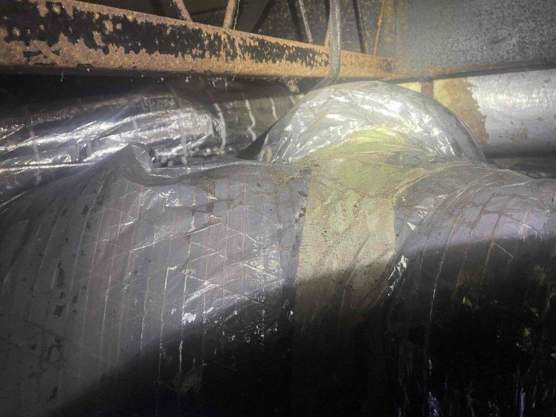 Responded to no cooling complaint on residential HVAC system. Upon inspection, accessed crawl space and evaluated ductwork system and structural conditions. Found flexible ductwork with visible deterioration including discolored tape connections and potential contamination on duct wrap material. Observed significant moisture damage to surrounding wooden structural members with advanced weathering and degradation. Documented conditions showing compromised crawl space environment with aged insulation, corroded piping, and moisture barrier flooring. Advised customer of findings and explained billing parameters for related versus unrelated repairs to original service call.