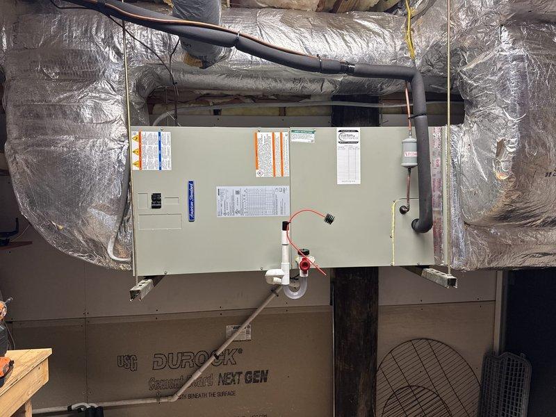Removed and disposed of existing first floor 3.5-ton HVAC system and completed full replacement installation. Installed 5A6H7036 3-ton 17 SEER heat pump outdoor unit on existing stand with new whip and disconnect. Installed 5TEM6D04 variable speed fan coil unit in attic with BAYHTR1715BRKR 15KW electric heater with breaker. Flushed, pressure tested, and recharged refrigeration lines to manufacturer specifications. Verified existing Honeywell programmable thermostat operation and integrated with new system. All equipment tested and confirmed operational upon completion.