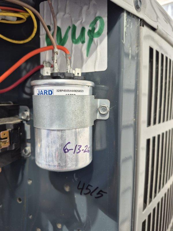 Responded to emergency no-cooling call on a fourteen-year-old residential air conditioning system. Upon inspection, identified a failed dual-run capacitor on the outdoor condensing unit. Replaced the defective JARD capacitor with new component, restored electrical connections, and verified proper system operation. Unit returned to normal cooling function.