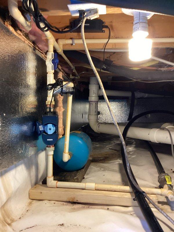 Installed a Moen 3/4" Wi-Fi valve adjacent to the tankless water heater with custom mounting using 2x4 framing and plywood backing. Performed extensive CPVC repiping in the crawlspace to accommodate the new valve installation, including replacement of the existing 3/4" CPVC main water ball valve. Installed new 3/4" brass FIP ball valve, 3/4" CPVC ball valve, male high-temperature adapters, and approximately 20 CPVC fittings with 10 feet of 3/4" CPVC pipe. Connected the Wi-Fi valve to the existing electrical outlet near the tankless unit. Additionally corrected the tankless water heater condensate line routing, which was previously terminating improperly through the floor above the sill plate, by repiping the condensate discharge line through the foundation wall to ensure proper drainage and prevent potential structural damage.